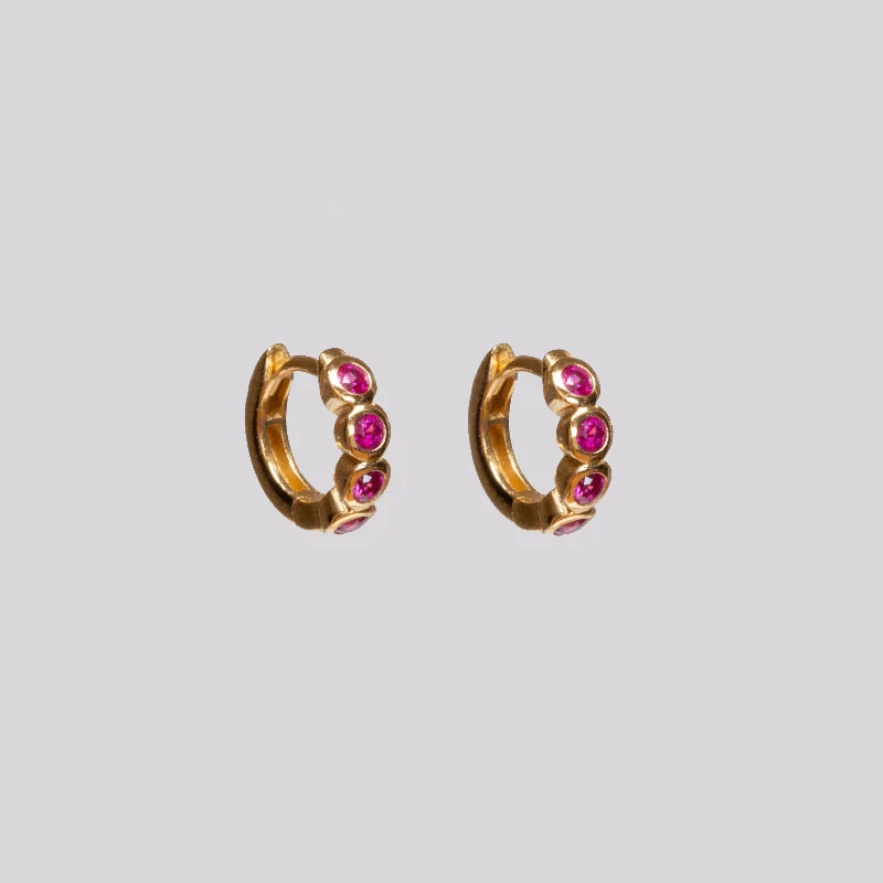 ladies earrings ethical-Gold Huggie Earrings with Ruby Pink Stone